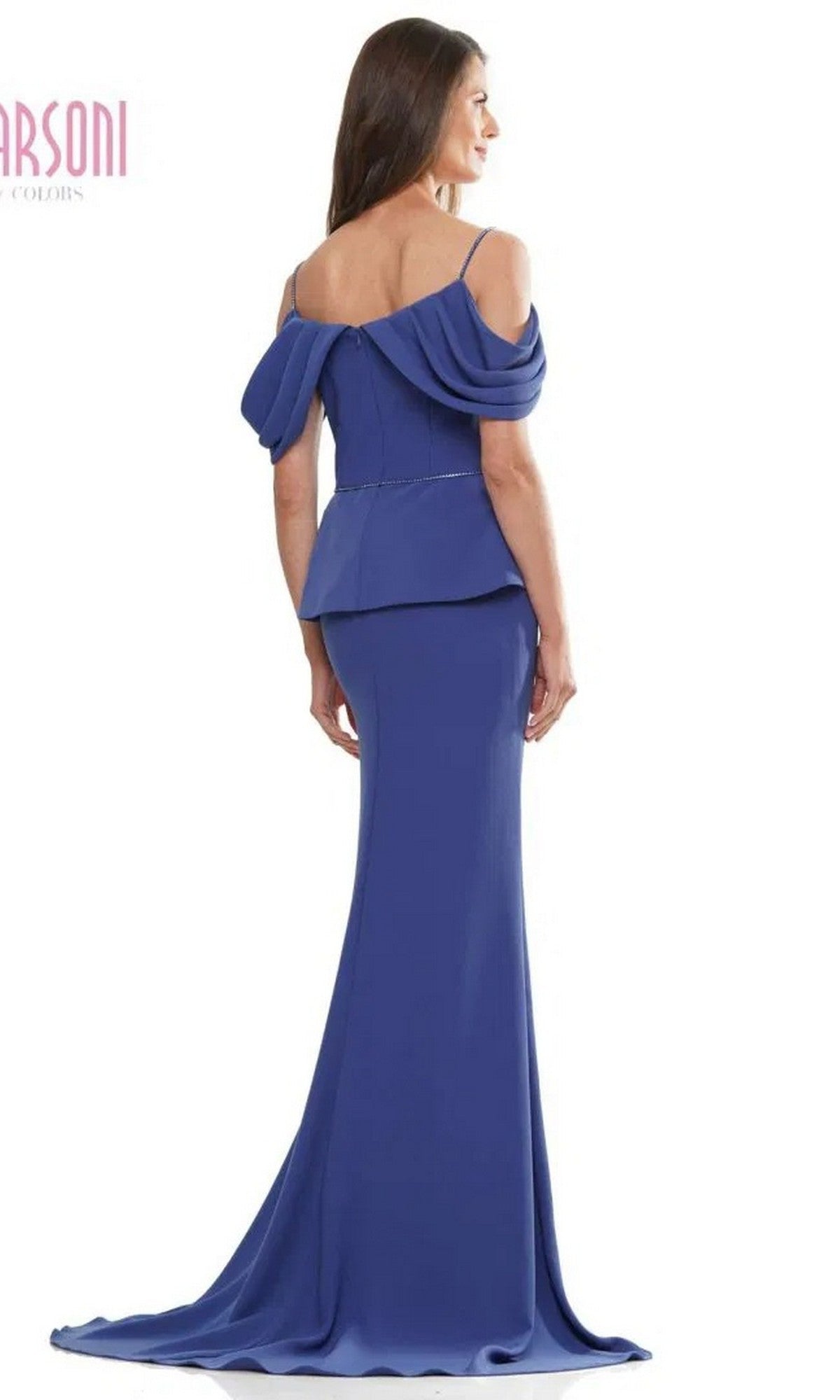Woman in a Marsoni MV1271 long formal dress featuring an off-the-shoulder blue design, fitted stretch crepe bodice, draped sleeves, and floor-length skirt, standing and facing away from the camera.